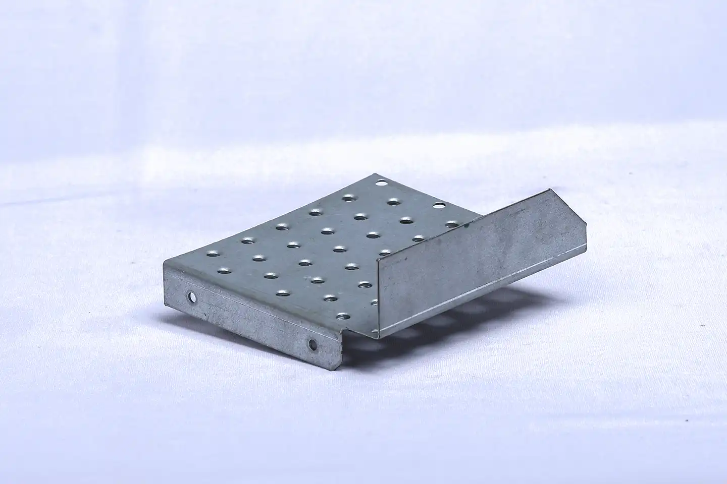 Industrial metal component with drilled holes